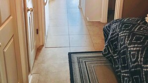 A hallway leading to a bedroom with a bed, a small kitchenette, and a bathroom. - 338 Ocean View!  Quiet Villa W/ Many Amenities 550 Sq FeetVRBO#394687 (Hilton Head Island)
