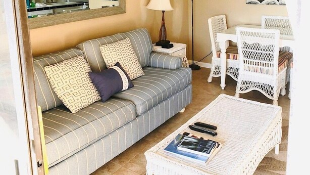A living room with a sofa, a coffee table, a lamp, and a dining set. - 338 Ocean View!  Quiet Villa W/ Many Amenities 550 Sq FeetVRBO#394687 (Hilton Head Island)
