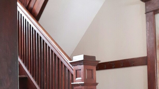 A wooden staircase with a handrail and a dark floor. - Beautiful 1921 brick and fieldstone Country Country ... The Tummel house (Roblin)