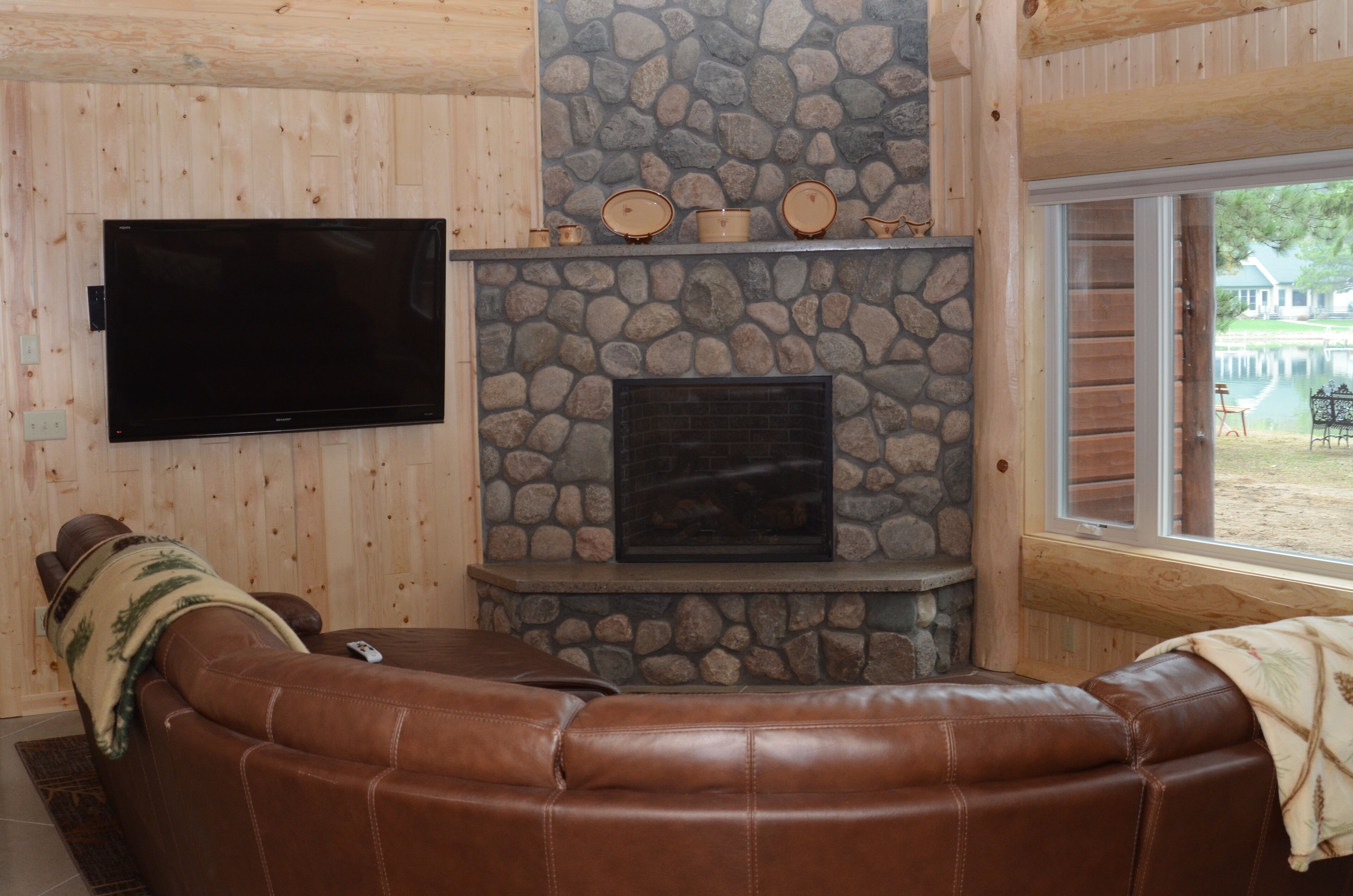 Spruce with two story high windows with loft on the premier lake of Big Sand