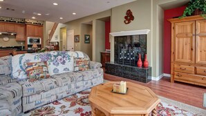 A living room with a sofa, coffee table, and a fireplace. - Carlsbad treasure in Calavera Hills (carlsbad)