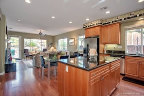 Enjoy cooking in this well-equipped kitchen with a central island and dining area nearby.