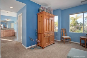 Enjoy a peaceful retreat with a window view of lush greenery and a comfortable chair.