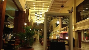 A spacious lobby with high ceilings, chandeliers, and a central archway. - Beachfront condo with full sea view and the facilities of a 5-star resort (Petchaburi)