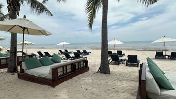 On the beach, sun loungers, beach towels