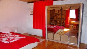 A bedroom with a large bed, a wardrobe with a mirror, and a small table with a chair. - Authentic 19th century house near Vans (Malons-Et-Elze)