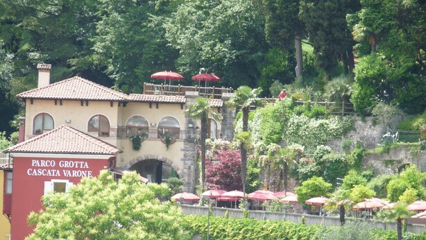 A building with a red facade and arched windows, labeled "PARCO GROTTA CASCATA VARONE." - TOWNHOUSE WITH GARDEN   (Gavazzo  Di Tenno)