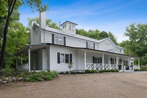 A large, single-story house with a covered porch and a gravel driveway. - "New" Lake Michigan R & R Recently Completed Major Rehab (Union Pier)