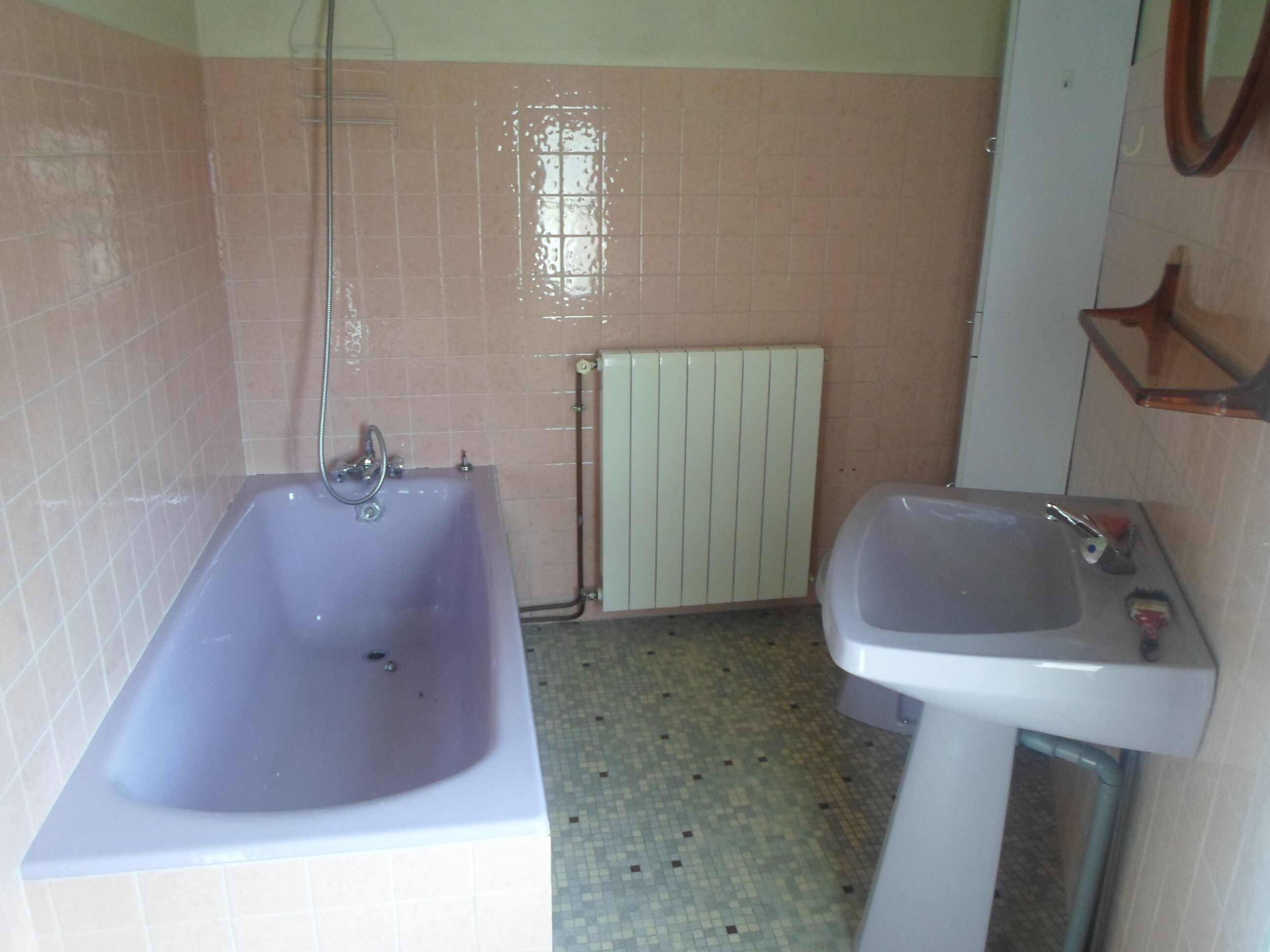 A bathroom with a bathtub, a sink, and a toilet.