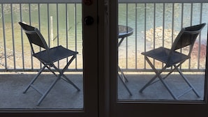 A room with a view of a lake and mountains, two folding chairs, and a small table. - Eagle View, Paradise! 2 Beds, Hot Tub, Beach (Nelson)