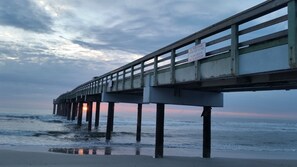 A pier extending over the water with a sunset in the background. - 2/2 Condo, Ground Floor, 2 Parking Spaces, Pool (Saint Augustine Beach)