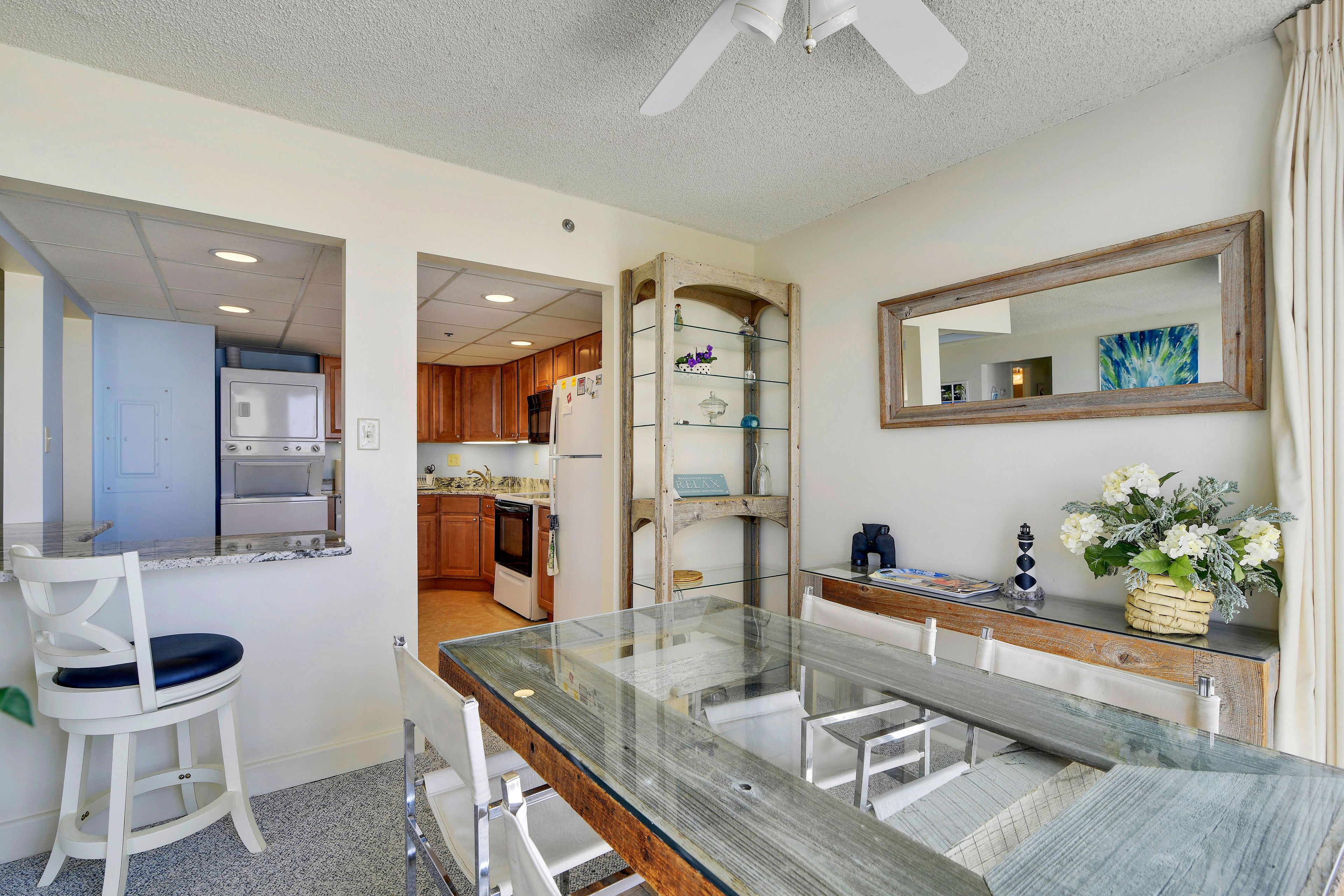 A modern kitchen with wooden cabinets, a built-in oven, and a refrigerator.