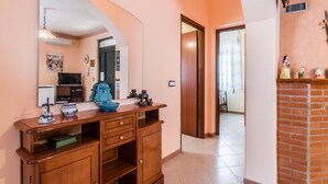 A bathroom with a wooden vanity, a mirror, a sink, and a toilet. - Red-house near the beach and with  (Avola-Siracusa)