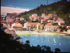 A coastal town with buildings on a hillside and boats on the water. - Apartment/ flat - Coruña (O Pindo)