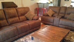 A living room with two brown leather sofas, a wooden coffee table, and a patterned rug. - River Access and just 3.5 miles from Downtown Franklin (Franklin)