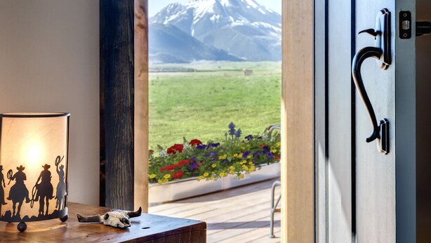 A wooden door with a metal handle and a keyhole, leading to a balcony with a mountain view. - Lone Cactus Ranch House Cottage Paradise Valley (Pray)