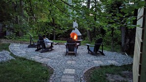 A stone pathway leading to a fire pit area with two Adirondack chairs and a stone table. - New Hope area Historical Bucks County Stone House circa 1732 (Lumberville)