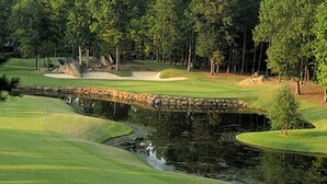 A golf course with a pond, sand bunkers, and trees. - Large 3 BR 2.5BA Lake Norman House in Birkdale Village,Close to Charlotte! (Huntersville)