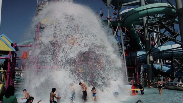 A water park with a large water slide and multiple water features.