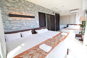 A hotel room with a stone wall, two beds, a large window, and an air conditioning unit. - L.O.A resort (Okinawa)