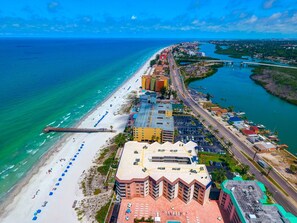 An aerial view of a coastal city with a beach, a marina, and a large hotel with multiple floors and a rooftop pool. - 3 bed 3 bath Penthouse Spectacular Panaoramic views of beach and intracoastal!!! (Indian Shores)