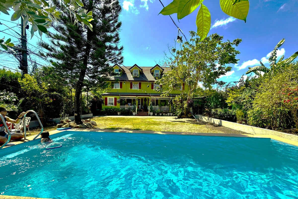 A swimming pool with a house in the background.
