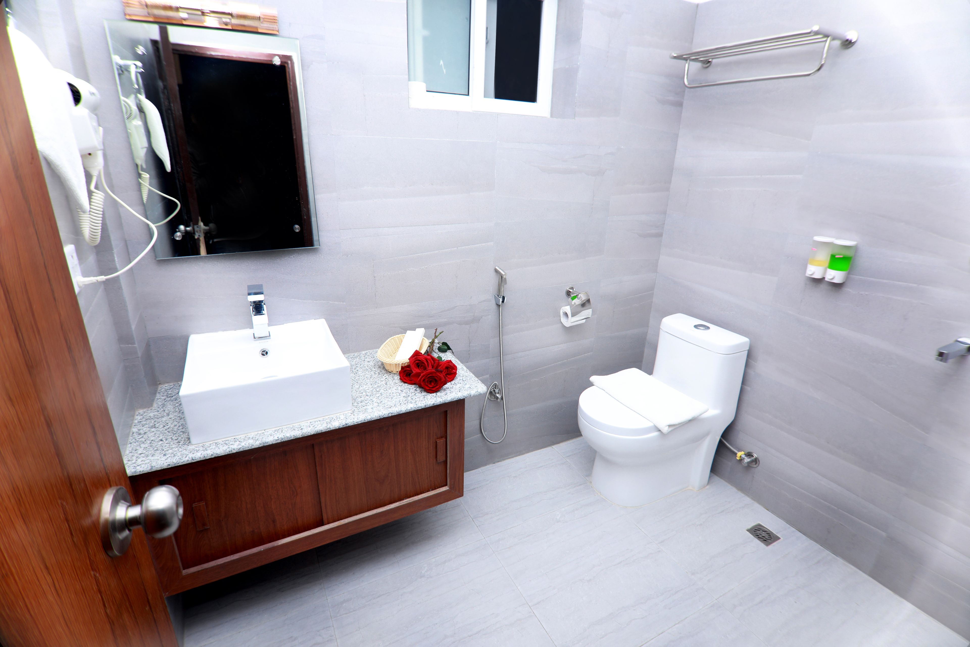 A modern bathroom with a sink, toilet, and shower.