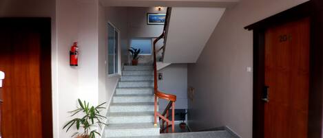 A staircase leading to a second floor, with a wooden door labeled "204" on the right.