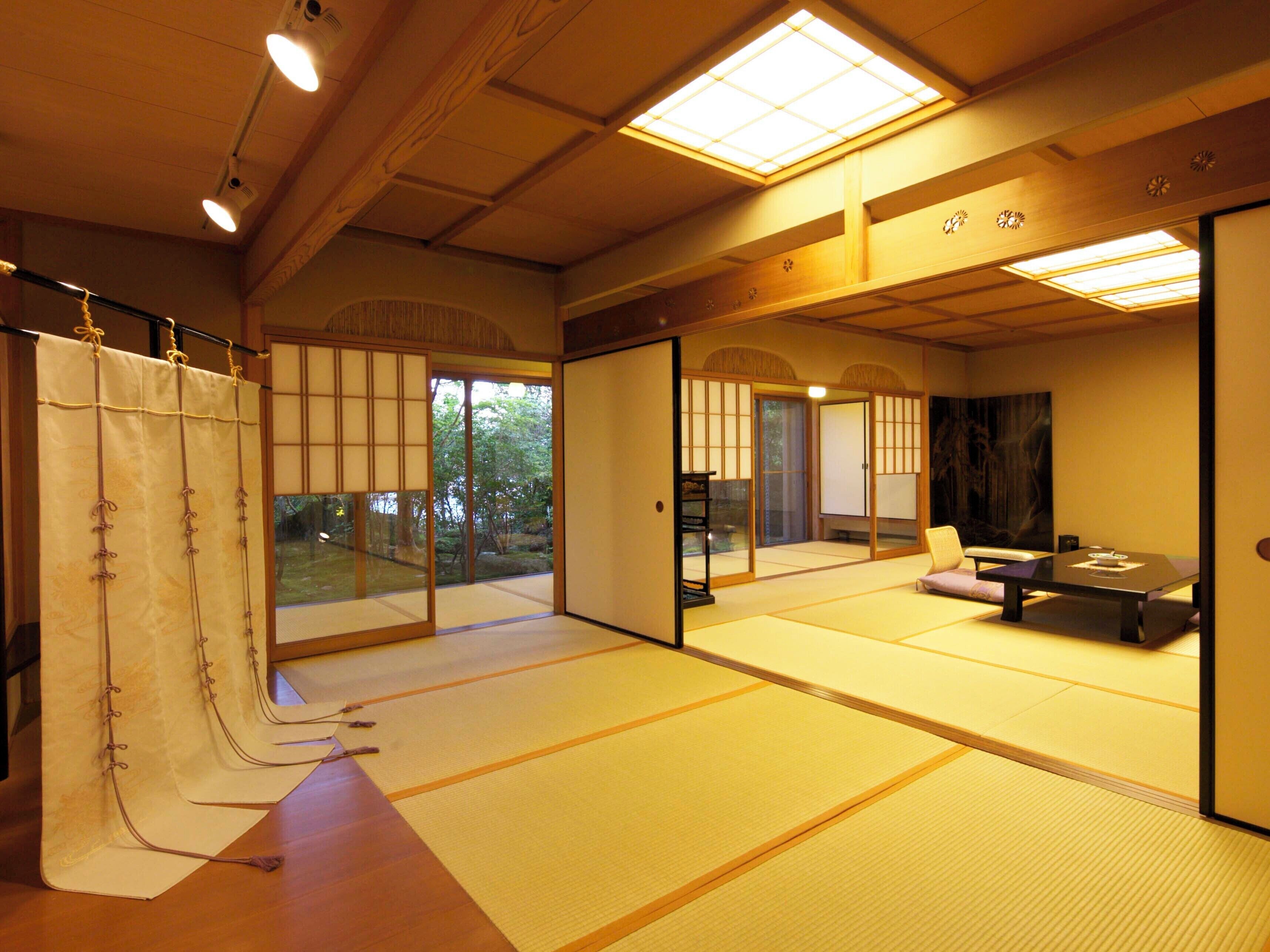 A traditional Japanese room with tatami flooring, sliding doors, and a low table.