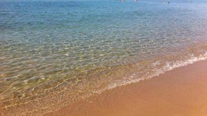 A beach with clear shallow water and a sandy shore. - Il Borghese Tourist House (Gela)