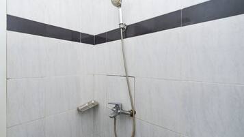 A shower with a handheld showerhead and a handheld faucet.