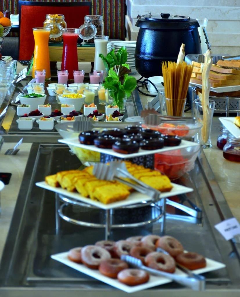 A buffet with various food items and beverages.