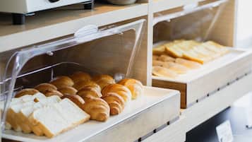 A bakery display with various baked goods like bread and croissants.