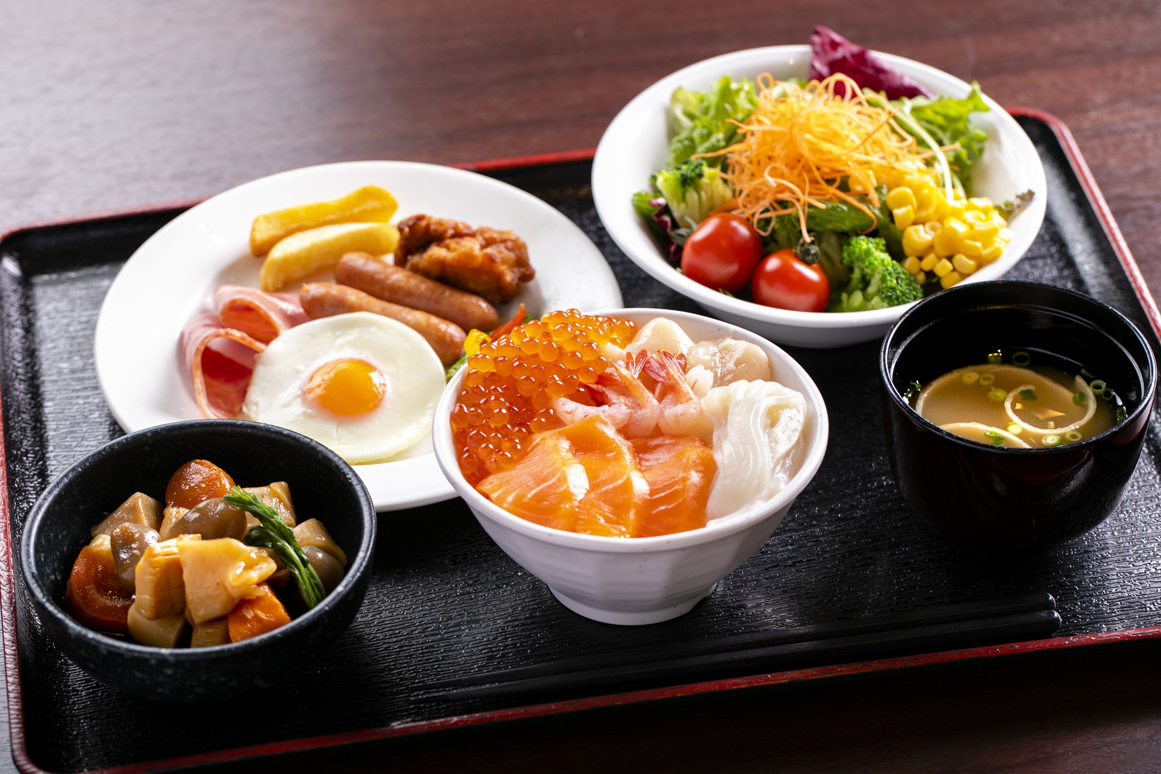 A tray with various dishes including a salad, a bowl of soup, and several plates of food.