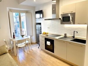 Appartement Tradition, vue cour intérieure | Cuisine privée | Grand réfrigérateur, micro-ondes, four, plaque de cuisson