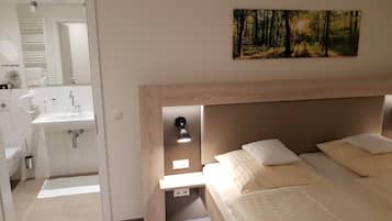 Ropa de cama hipoalergénica y caja de seguridad en la habitación