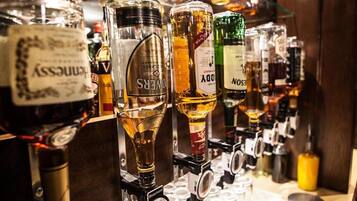 A bar with various liquor bottles and a wine cooler.