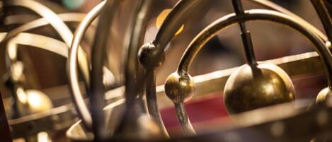 A close-up of a metal structure with spherical elements and a central spherical object, likely part of a larger architectural feature.