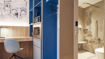 A modern bathroom with a shower, toilet, and a sink.