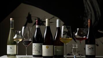 A selection of wine bottles and glasses on a table.