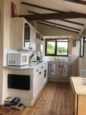 Cottage, meerdere bedden | Privékeuken | Een koelkast, een magnetron, kookgerei, borden en bestek