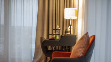 A room with a dining table, chairs, a lamp, and a decorative item on the table.