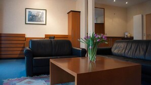 Un salon moderne avec un canapé, une table basse et un vase de fleurs.
