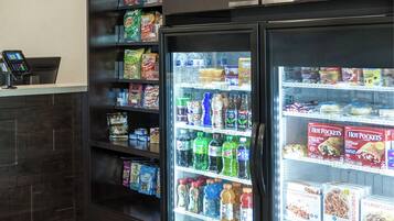 A self-service beverage station with a variety of drinks and snacks.