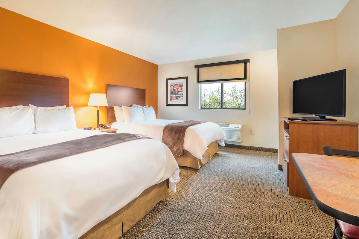 Premium bedding, pillow-top beds, desk, laptop workspace