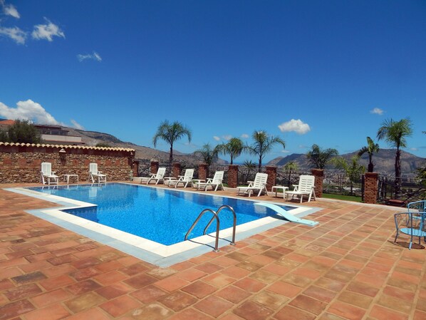 Seasonal outdoor pool, open 10:00 AM to 6:00 PM, pool loungers