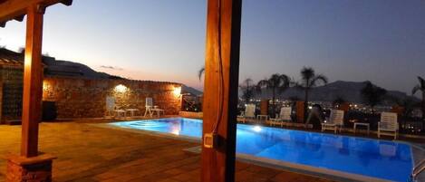 Seasonal outdoor pool, open 10:00 AM to 6:00 PM, pool loungers