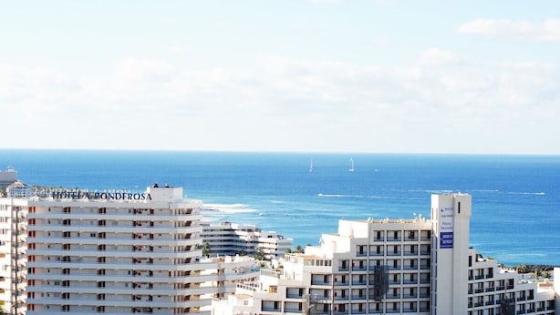 A coastal hotel with multiple floors, balconies, and a view of the sea. - Villa Casa Blanca (Costa Adeje)