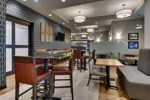 Enjoy a meal in our contemporary dining area with booths and tables, featuring a clean and inviting atmosphere.