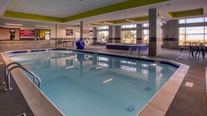 An indoor swimming pool with clear signage, a lifeguard chair, and a view of the outdoors. - Drury Inn & Suites Columbus Polaris (Columbus)
